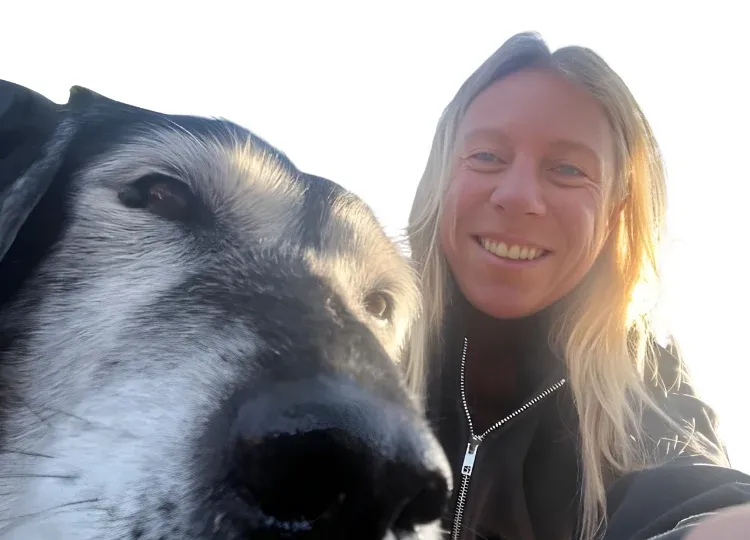 Jess of Workday Wags out on a North Loop sidewalk with a happy dog on leash